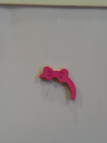 Hair bow from a doll set, inside Dani's cast.