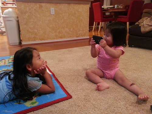 Dani pretending to take a video of Amelie.