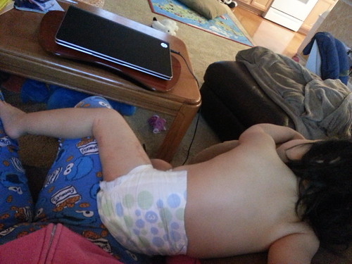 Watching TV and resting on Mommy.